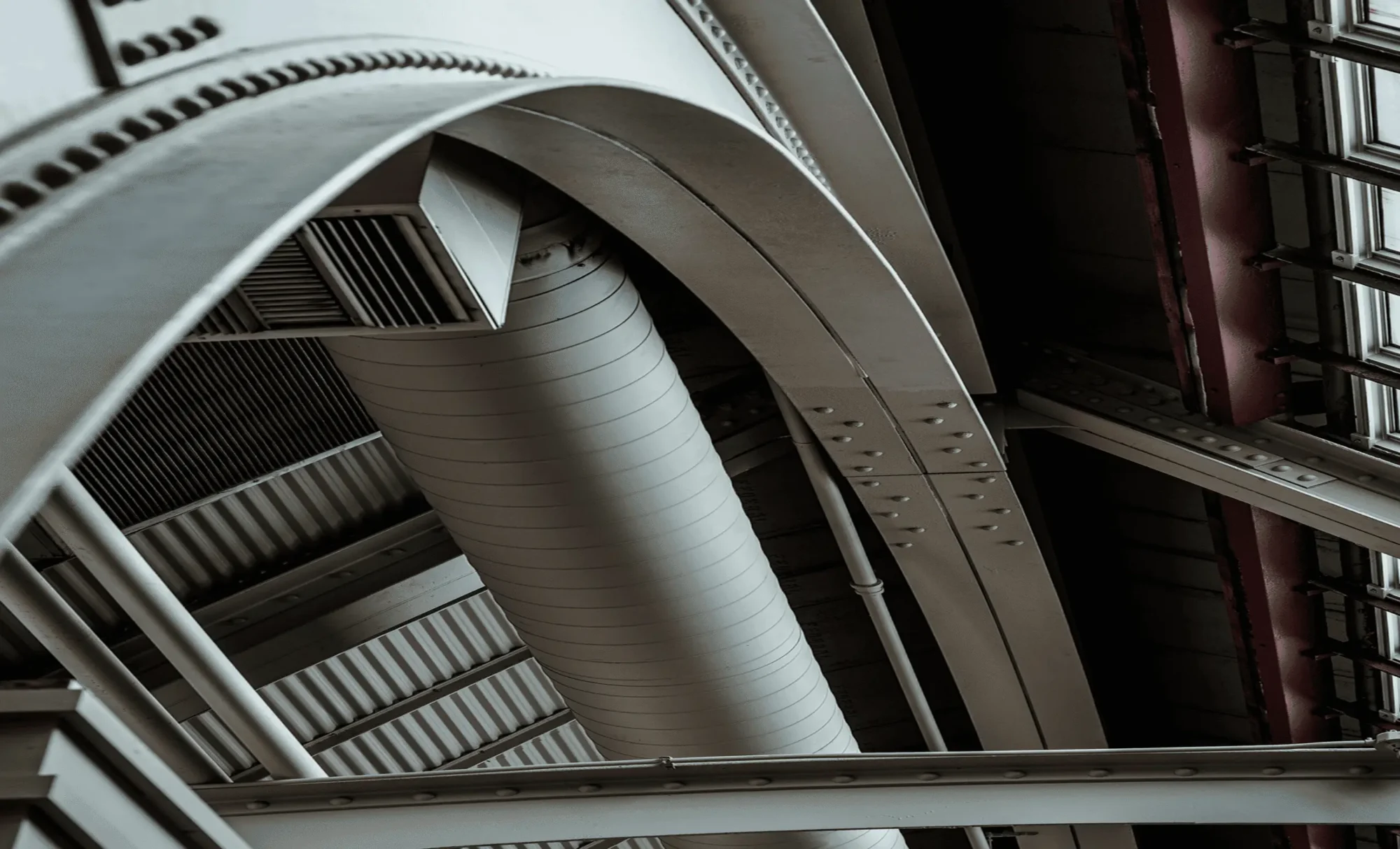 detailed photo of an industrial roof with exposed ducts